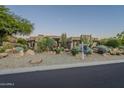 Desert landscape with a stucco home and a for sale sign at 24005 N 45Th Dr, Glendale, AZ 85310