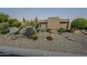Xeriscaped front yard with stucco home, moon visible at 24005 N 45Th Dr, Glendale, AZ 85310