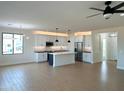 Open concept kitchen with island, stainless steel appliances, and white shaker cabinets at 58Xx N Nigal Rd, Casa Grande, AZ 85194