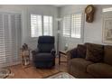 Bright living room with comfy seating, wood floors, and large windows at 1318 W Chesapeake Dr, Apache Junction, AZ 85119