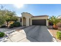 Single-story home with a two-car garage and landscaped front yard at 22677 E Desert Spoon Dr, Queen Creek, AZ 85142