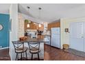 Well-equipped kitchen featuring wood cabinets and breakfast bar at 8315 E Desert Trl, Mesa, AZ 85208