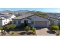 Modern home with tile roof, landscaping, and mountain views at 16375 S 180Th Dr, Goodyear, AZ 85338