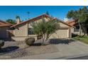 Tan two-car garage home with a terracotta tile roof at 2164 S Catarina --, Mesa, AZ 85202