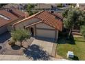 Aerial view of a tan two-car garage home with a terracotta tile roof at 2164 S Catarina --, Mesa, AZ 85202