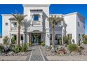 Luxury home exterior with palm trees and stone pathway at 1480 E Raven Ct, Gilbert, AZ 85297