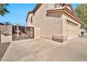 View of the garage and side of the house with a wooden gate at 6782 W Firebird Dr, Glendale, AZ 85308