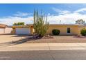 Single story home with desert landscaping and a two-car garage at 10637 W Welk Dr, Sun City, AZ 85373