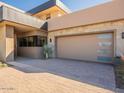 Three-car garage with modern door and paver driveway at 37200 N Cave Creek Rd # 1002, Scottsdale, AZ 85262
