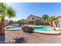 Relaxing kidney shaped pool with rock waterfall feature at 18525 N Madison Rd, Maricopa, AZ 85139