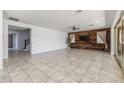 Bright living room with wood accent wall and tile flooring at 9645 E Theia Dr, Mesa, AZ 85212