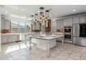 Spacious kitchen featuring an island, stainless steel appliances, and pendant lighting at 9645 E Theia Dr, Mesa, AZ 85212