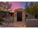 Custom metal gate entry to a beautiful property with stone accents at 9422 E Diamond Rim Dr, Scottsdale, AZ 85255