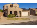 Two-story house with solar panels and a two-car garage at 16170 W Port Royale Ln, Surprise, AZ 85379