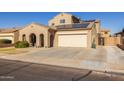 Two-story house with solar panels and a two-car garage at 16170 W Port Royale Ln, Surprise, AZ 85379