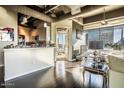 Modern living room with hardwood floors, large windows, and city views at 1 E Lexington Ave # 410, Phoenix, AZ 85012