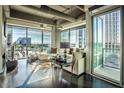 Spacious living room featuring hardwood floors and floor to ceiling windows at 1 E Lexington Ave # 410, Phoenix, AZ 85012