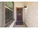 Inviting front entrance with security door and light fixture at 42488 W Lucera Ct, Maricopa, AZ 85138