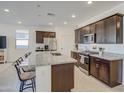 Modern kitchen with granite countertops and dark wood cabinets at 2956 E Monsoon Dr, San Tan Valley, AZ 85140