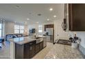 Modern kitchen with granite countertops and stainless steel appliances at 2956 E Monsoon Dr, San Tan Valley, AZ 85140