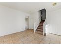 Bright entryway with tiled floor and staircase at 1434 E Romley Ave, Phoenix, AZ 85040
