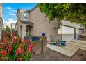 Two-story house with colorful flowers and a double garage at 13349 N 87Th Ln, Peoria, AZ 85381