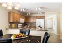 Kitchen with granite countertops, wood cabinets, and breakfast bar at 28629 N Zircon Ct, San Tan Valley, AZ 85143