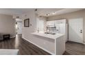 Modern kitchen with white cabinetry and breakfast bar at 9550 E Thunderbird Rd # 155, Scottsdale, AZ 85260