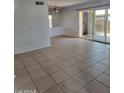 Spacious living room with tile floors and sliding glass doors at 5906 W Townley Ave, Glendale, AZ 85302