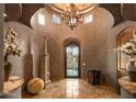 Elegant entryway with high ceilings and a chandelier at 9533 E Rising Sun Dr, Scottsdale, AZ 85262