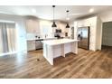 Modern kitchen with island, stainless steel appliances, and white cabinetry at 310 N Brower Rd, Maricopa, AZ 85139