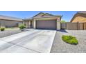 Single-story home with a brown garage door and neutral color scheme at 823 S Silvercreek Ct, Casa Grande, AZ 85122