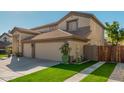 Two-story house with a three-car garage and wooden gate at 959 W Myrtle Dr, Chandler, AZ 85248