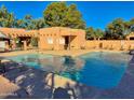 Community pool with surrounding lounge chairs at 8940 W Olive Ave # 134, Peoria, AZ 85345