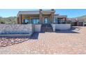 Back exterior showcasing stonework and landscaping at 14914 E Zapata Dr, Fountain Hills, AZ 85268