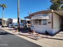 Mobile home exterior with landscaping and parking at 9333 E University Dr # 89, Mesa, AZ 85207