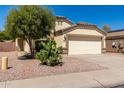 Two-story home with a two-car garage and desert landscaping at 2091 N Coronado Ct, Casa Grande, AZ 85122