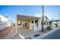 Inviting exterior with covered patio and well-maintained landscaping at 648 Hawks Eye Dr # 648, Apache Junction, AZ 85119