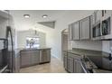 Modern kitchen with gray cabinets and stainless steel appliances at 3114 E Winged Foot Dr, Chandler, AZ 85249