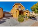 Exterior view of a two-story house with a driveway, attached garage, and desert landscaping at 2090 S Moccasin Trl, Gilbert, AZ 85295