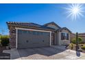 Single story home with gray exterior and a two-car garage at 26819 W Zachary Dr, Buckeye, AZ 85396