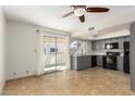 Bright kitchen with gray cabinets, black appliances, and tile floor at 16053 N 26Th Cir, Phoenix, AZ 85023