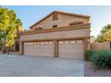 Two-story home with three-car garage and desert landscaping at 13128 N 104Th Pl, Scottsdale, AZ 85260