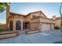 Two-story home with three-car garage and desert landscaping at 13128 N 104Th Pl, Scottsdale, AZ 85260