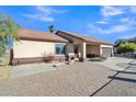 House exterior with gated driveway and landscaping at 5514 E Santa Clara Dr, San Tan Valley, AZ 85140