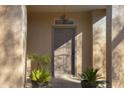 Inviting front door entry with columns and potted plants at 26853 N 176Th Dr, Surprise, AZ 85387