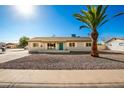 Single story home with a teal door, and rock landscaping at 101 W Shannon St, Chandler, AZ 85225
