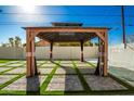 Covered patio with seating area, artificial turf, and a beautiful design at 101 W Shannon St, Chandler, AZ 85225