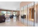 Spacious living room with tile floors, large windows, and a view into the kitchen at 19620 N Majestic Vista Ct, Surprise, AZ 85387