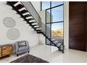 Modern metal staircase with wood steps and access to upper floor at 18475 W Eagle Dr, Goodyear, AZ 85338